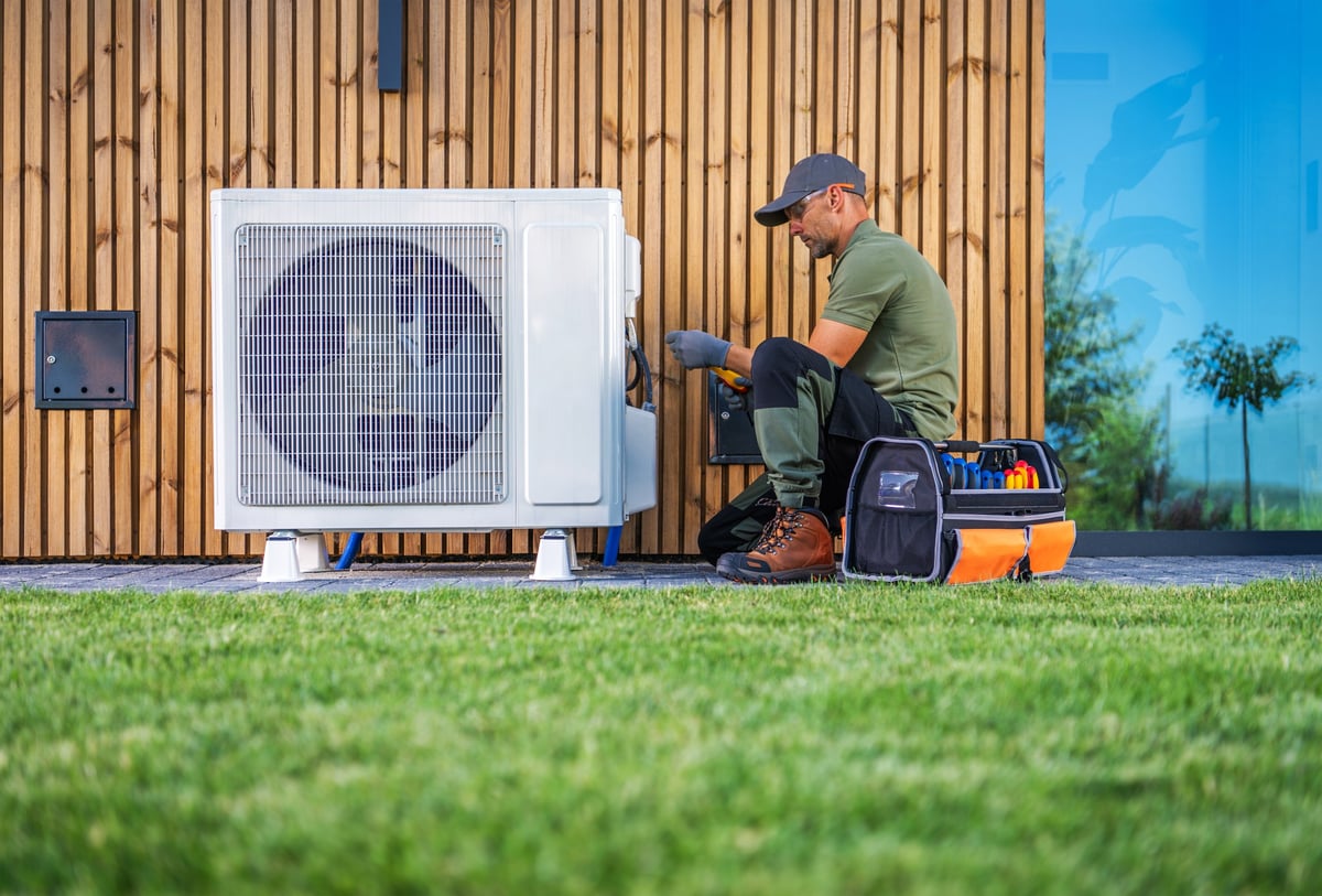 Professional HVAC technician servicing a home